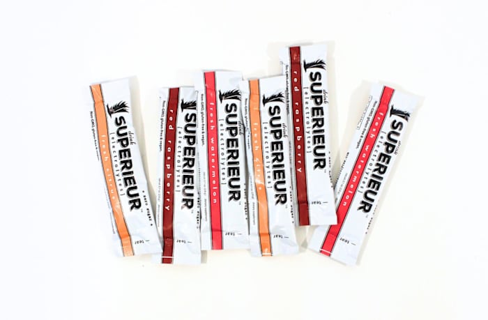 Superieur electrolyte travel packets in various flavors against a white background